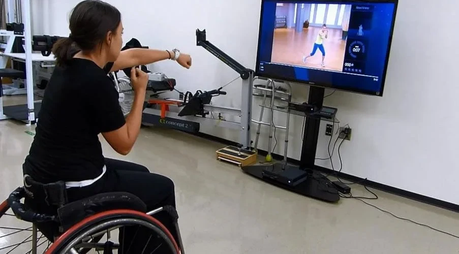 Girl in wheelchair playing video games