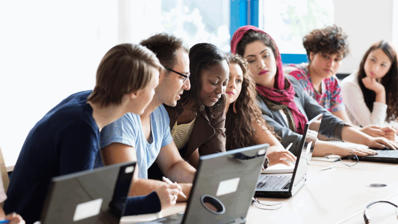 Group of people looking at a laptop