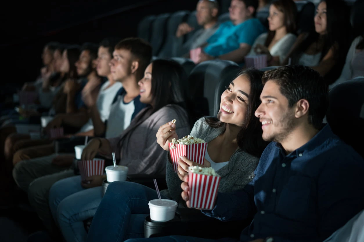 Couple eating popcorn in the cinema