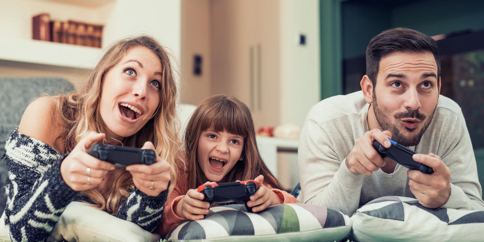 Family of three playing video games