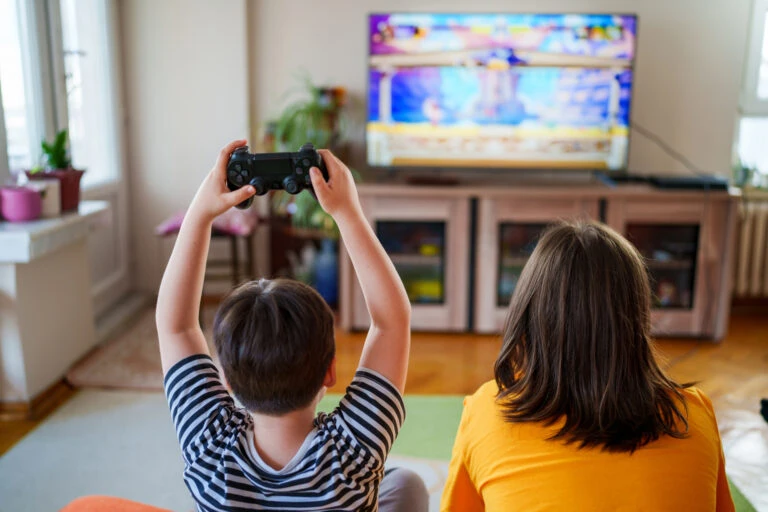 Children playing a video game on a living room TV.